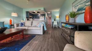 a living room with a couch and a table at Oceanview Surf Condo 517 with Pool Beach Access in Surf City