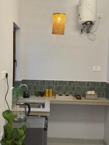 a kitchen with a sink and a counter top at Casa Susegado in Taleigao +10 photos
