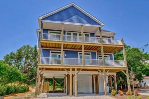 a large blue house with a large balcony at Good Vibes - Ocean View Home With Elevator in Surf City