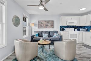 a living room with a couch and a table at Oceanview Condo - Sea Coast Suites 18 in Surf City, NC in Surf City