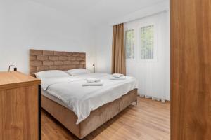 Postel nebo postele na pokoji v ubytování Apartments Dončić