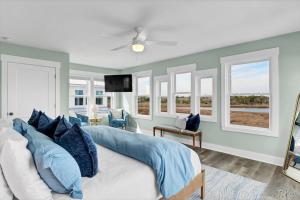 a bedroom with blue walls and a bed with blue pillows at Dog Friendly | Waterfront | Surf City, NC | 2 Master Suites | Elevator in Surf City
