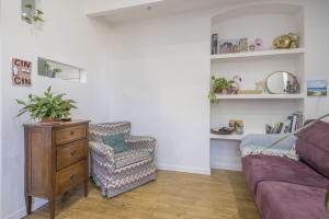 a living room with a couch and a chair at Central Cozy Nest With Parking, Bogliasco in Bogliasco