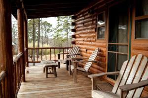 a porch of a log cabin with chairs on it at Wild Plum Cabin No.1 in Eureka Springs