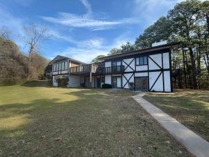 a large white and black house with a yard at Hidden Oasis Near Downtown in Eureka Springs