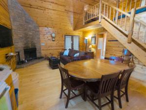 a living room with a wooden table and a couch at Wild Plum Cabin No. 3 in Eureka Springs