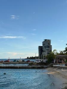 a view of a beach with a city in the background at Modern Condo in Mactan Newtown - OPR Tower B in Lapu Lapu City +2 photos