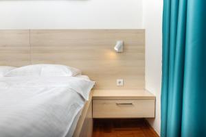 Postel nebo postele na pokoji v ubytování Apartments Dončić