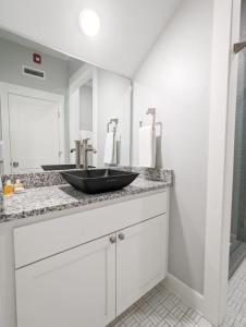 a bathroom with a black bowl sink on a counter at Entire Building at 151 Spring in Eureka Springs +28 photos