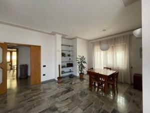 a living room with a wooden table and chairs at b&b Adelina in Lanciano
