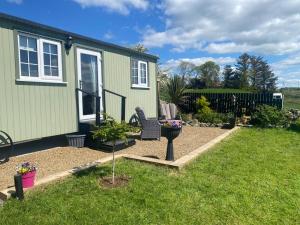 a backyard with a tiny house with a garden at Corrib view cabin in Clonbur