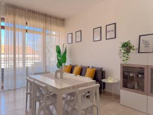a white dining room with a table and a couch at Vittorio Veneto - Spacious and Bright by Host Hero in Civitanova Marche +29 photos