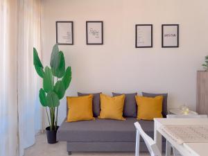 a living room with a gray couch and yellow pillows at Vittorio Veneto - Spacious and Bright by Host Hero in Civitanova Marche