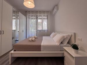 a bedroom with a bed with a teddy bear on it at Vittorio Veneto - Spacious and Bright by Host Hero in Civitanova Marche
