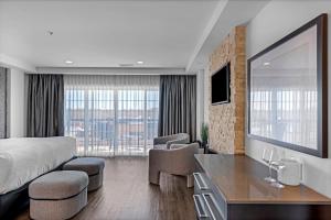 a hotel room with a bed and a desk and chairs at Hôtel Shediac in Shediac +40 photos