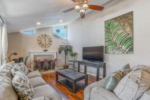 a living room with a couch and a table at F-66 Poolside Retreat in Anaheim