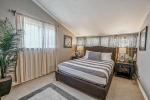 a bedroom with a bed and a large window at F-66 Poolside Retreat in Anaheim +21 photos