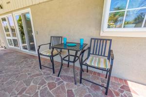a table with two chairs and a table with two glasses on it at F-66 Poolside Retreat in Anaheim