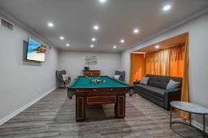 a living room with a pool table and a couch at F-65 Adventure House in Anaheim