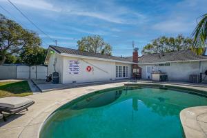 a swimming pool in front of a house at F-65 Adventure House in Anaheim