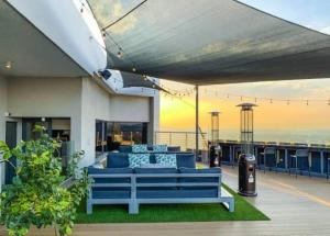 a blue couch sitting on top of a house at Menlyn Maine Trilogy Apartment 519 in Pretoria