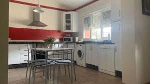 a kitchen with a table and chairs in a kitchen at El Mirador del Abuelo in Cabeza del Buey