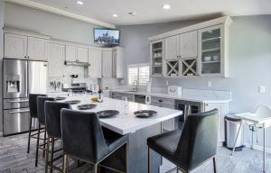 a kitchen with a large island with bar chairs at F-58 Mandos Hideaway in Anaheim