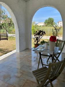 a patio with a table and chairs and a view at Cielo Mar in Mólos