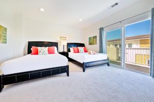 a bedroom with two beds and a large window at F-56 Winnie the Poohs Treehouse in Anaheim