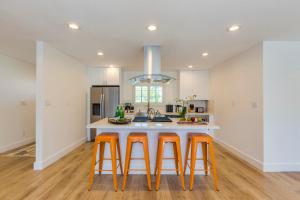 a kitchen with orange bar stools and a sink at F-54 Maverick in Anaheim