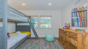 a bedroom with a bunk bed with a ladder at F-53 Trenton in Anaheim +16 photos
