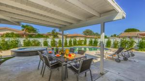 a patio with a table and chairs and a pool at F-53 Trenton in Anaheim