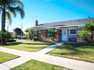 a house with a palm tree in the yard at F-29 The Pirates Cove in Anaheim