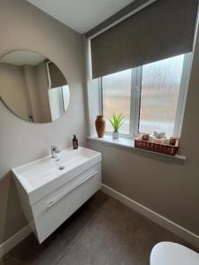 a bathroom with a white sink and a mirror at The CLYDE in Melrose