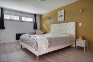 a bedroom with a large white bed and a window at Maison ANA in Équemauville +14 photos