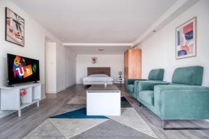 a living room with a couch and a tv at Maison ANA in Équemauville