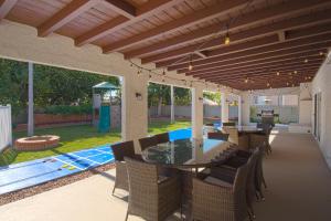 a patio with a table and chairs and a pool at F-16 Pirates Lair in Anaheim