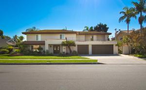 a large house with a garage and palm trees at F-16 Pirates Lair in Anaheim