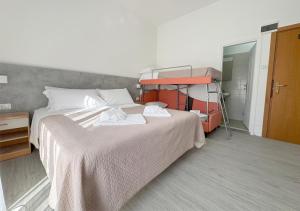 a bedroom with a bed with towels on it at Hotel Ariva in Rimini