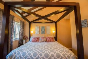 a bedroom with a large bed in a room at Bedknobs and Broomsticks by Funtierland Vacation Rentals in Anaheim +14 photos