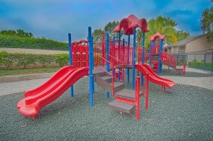 a playground with a red and blue slide at Under the Sea by Funtierland Vacation Rentals in Anaheim