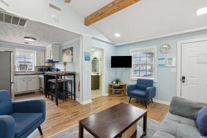 a living room with a couch and a table at 23 Center St - Sunny Side Up - Upstairs Apartment in Folly Beach