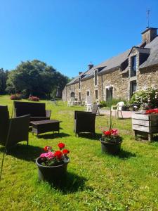 a group of chairs and flowers in a yard at La longére du Lesty in Ambon +27 photos