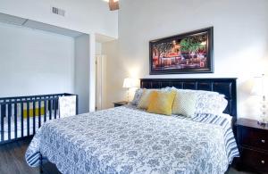 a bedroom with a bed and a picture on the wall at Tron by Funtierland Vacation Rentals in Anaheim +21 photos