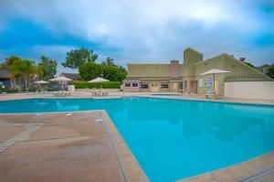 a large blue swimming pool in front of a building at Tron by Funtierland Vacation Rentals in Anaheim