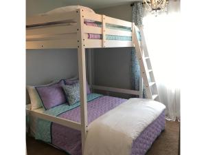 a bunk bed with a ladder in a room at Arendelle by Funtierland Vacation Rentals in Anaheim