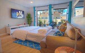 a living room with two beds and a couch at Love Bug by Funtierland Vacation Rentals in Anaheim +20 photos