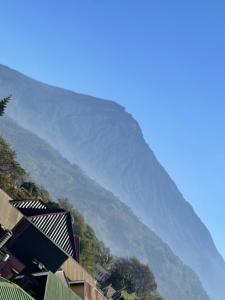 a mountain in the distance with houses and trees at QD Apartment in Arusha