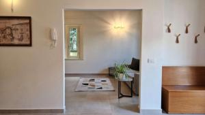 a hallway with a living room with a couch and a table at Camere AL Borgo in Santa Sofia