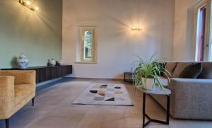 a living room with two couches and a rug at Camere AL Borgo in Santa Sofia +48 photos